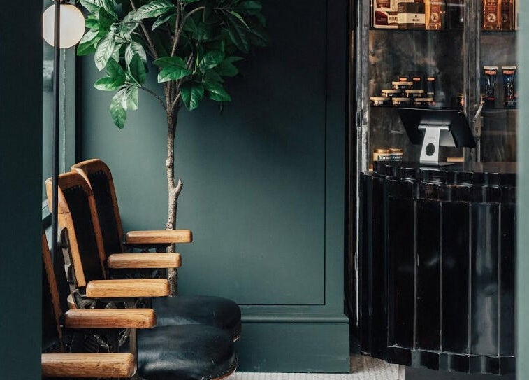 Stylish seating and reception at Anvil Barbers, London, England, GB with sleek decor and natural elements.