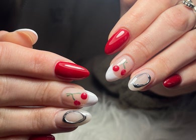 Elegant cherry nail art at Kara Beauty in Cape Town, Western Cape, ZA. Stunning red and silver manicure.