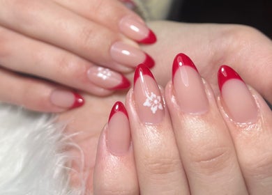 Elegant red-tipped manicured nails at Kara Beauty, Cape Town, Western Cape, ZA showcasing intricate design.