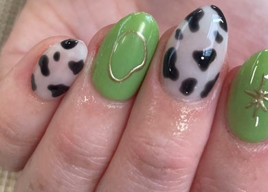 Stylish nail art with green and black designs at Evergreen Beauty, Desborough, England, GB.