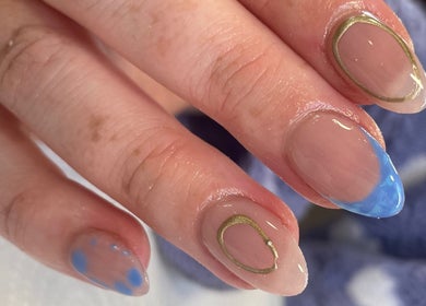 Stylish blue and gold nail art at Evergreen Beauty in Desborough, England, GB.