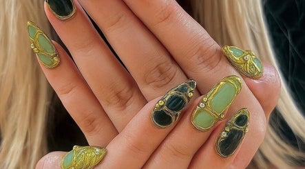Intricate nail art at Evergreen Beauty and Wellness, Desborough, England, GB showcasing unique green and gold designs.
