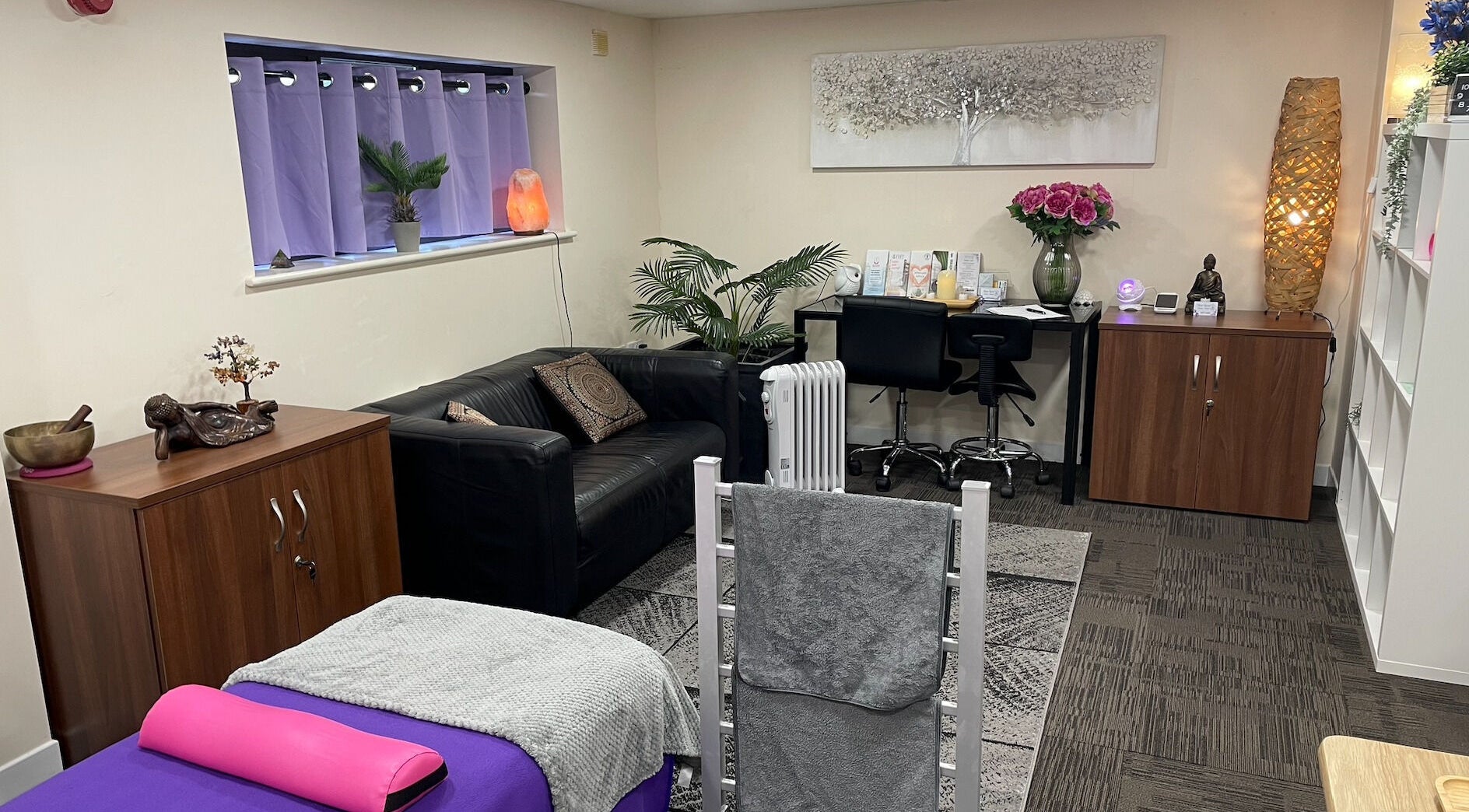 Cozy wellness room at Silver Spiral Holistic Health, Tiptree, England, GB with sofa, massage bed, and calming decor.