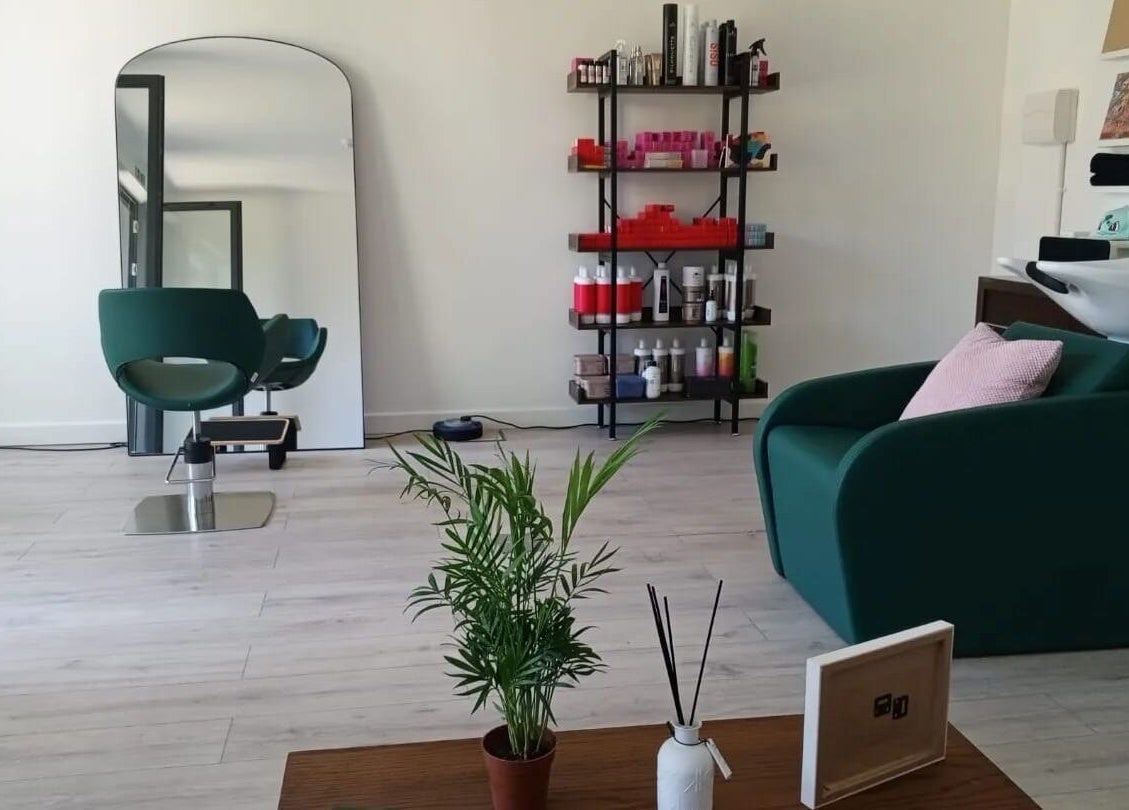 Modern interior of The Good Hair Studio in London, England, GB featuring styling chair and shelves with products.