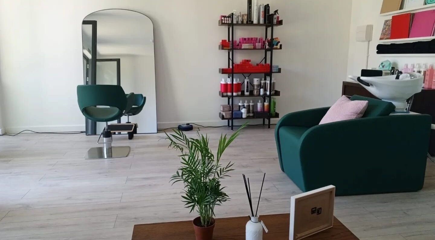 Modern interior of The Good Hair Studio in London, England, GB featuring styling chair and shelves with products.