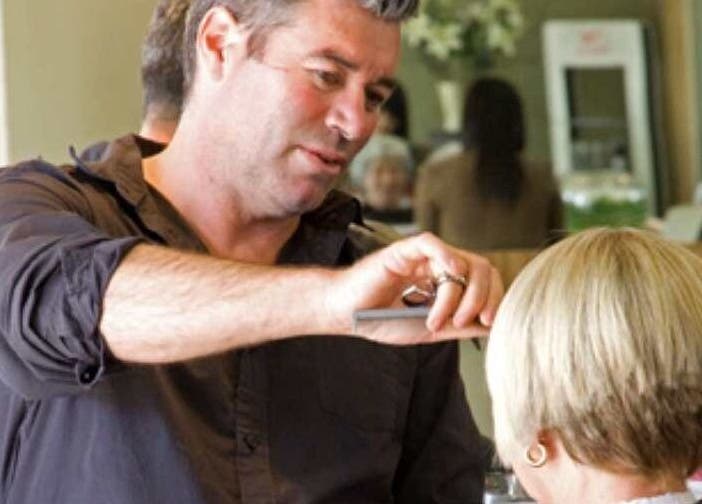 Expert stylist at Simon Cotter Edge Salon, Bay of Plenty, NZ, crafting a chic haircut.