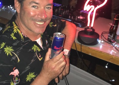 Relaxed man with drink at Simon Cotter Edge Salon, Bay of Plenty, NZ.