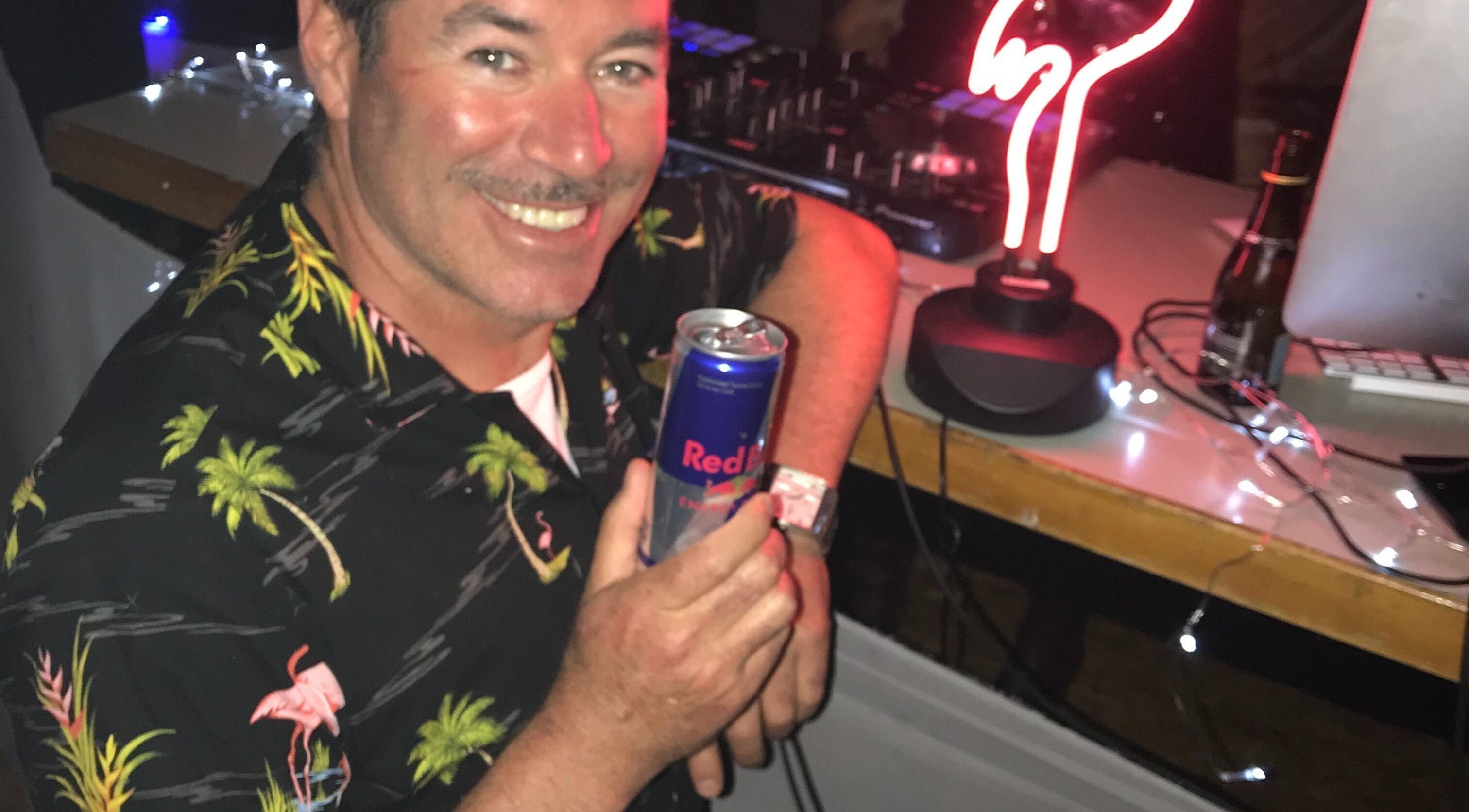 Relaxed man with drink at Simon Cotter Edge Salon, Bay of Plenty, NZ.