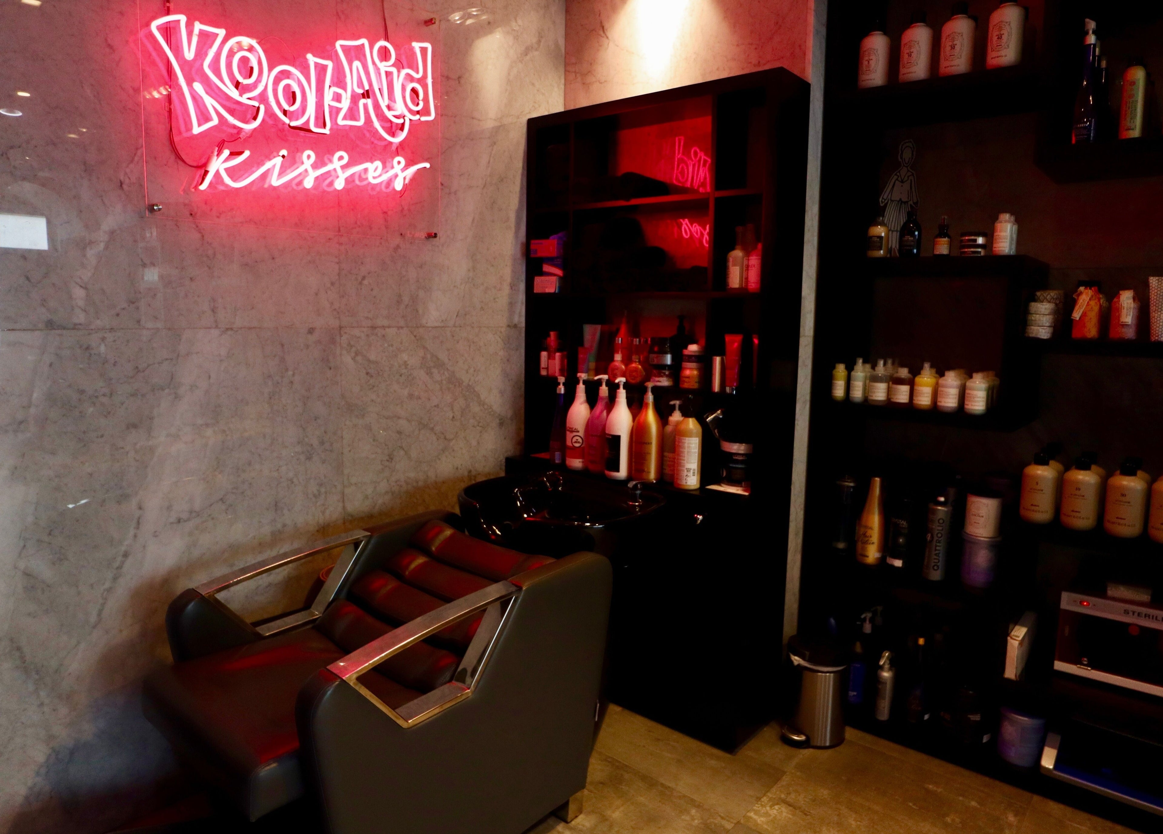 Chic salon corner at The Nail Pavilion JLT, Dubai, Dubai, AE, featuring a wash station and vibrant products.