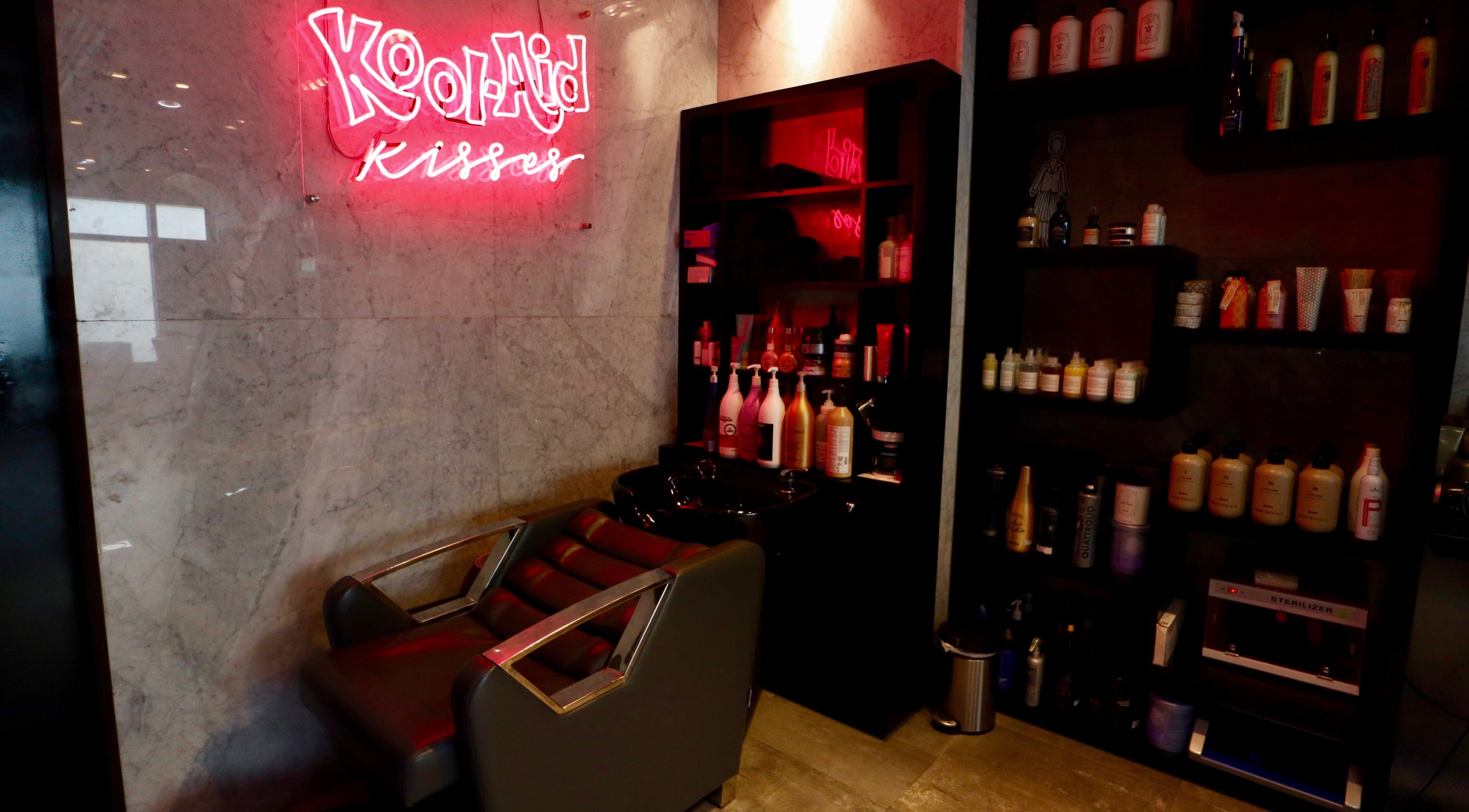 Chic salon corner at The Nail Pavilion JLT, Dubai, Dubai, AE, featuring a wash station and vibrant products.