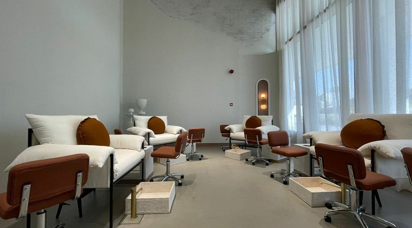 Luxurious seating area at The Nail Pavilion Salon in دبي, دبي, AE, featuring plush chairs and soft lighting.