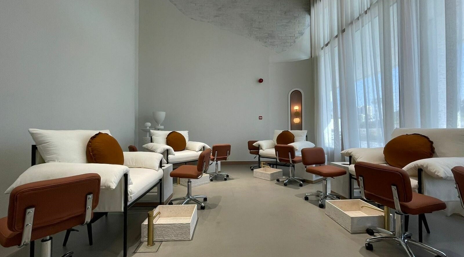 Luxurious seating area at The Nail Pavilion Salon in دبي, دبي, AE, featuring plush chairs and soft lighting.