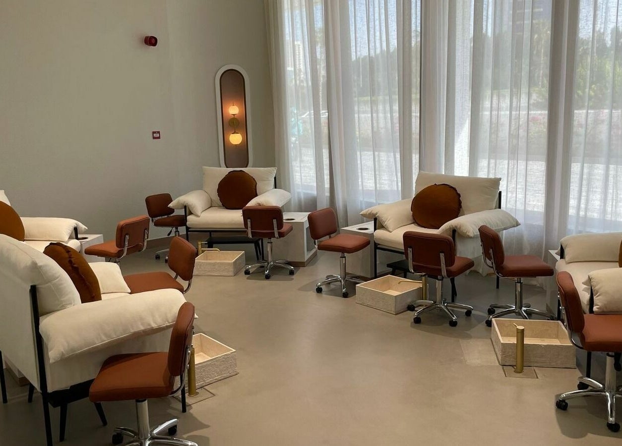 Cozy pedicure area at The Nail Pavilion Salon in دبي, دبي, AE, featuring plush chairs and stylish decor.