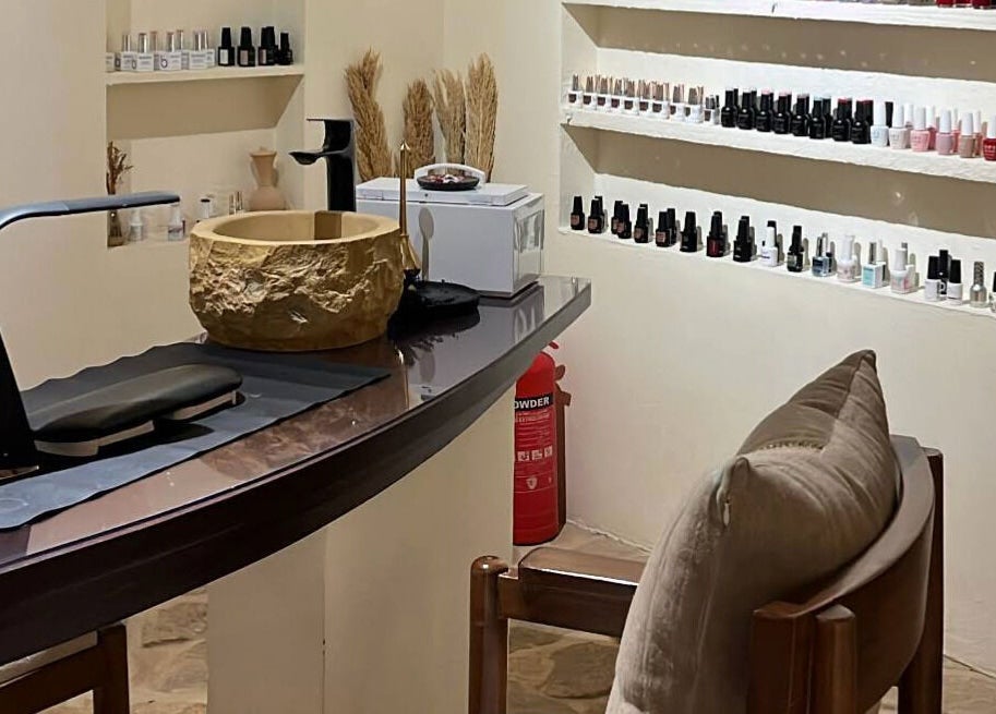 Nail salon interior at Hisma Spa in Riyadh, Riyadh Province, SA featuring manicured setup and nail polish display.