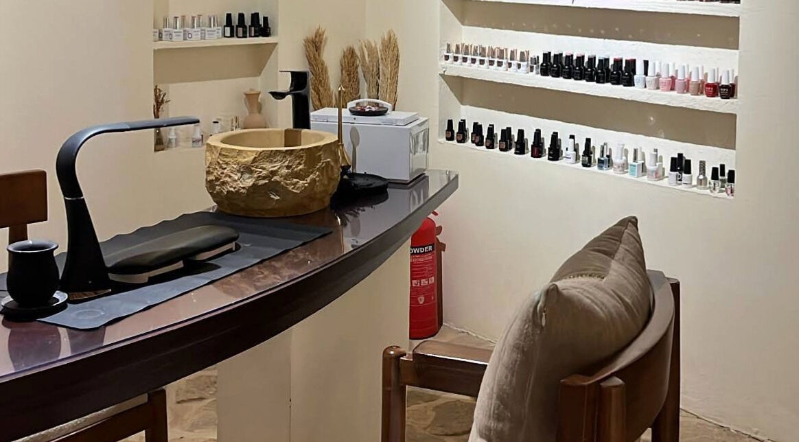 Nail salon interior at Hisma Spa in Riyadh, Riyadh Province, SA featuring manicured setup and nail polish display.