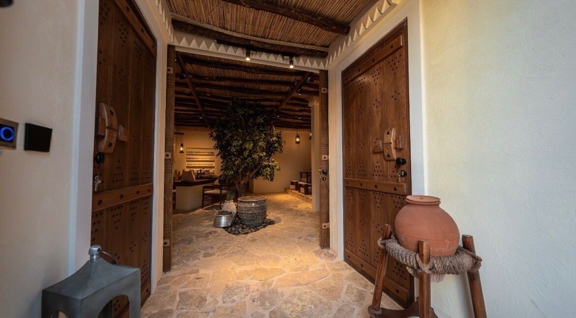 Rustic entrance at Hisma Spa, Riyadh, Riyadh Province, SA, featuring wooden doors and natural decor.