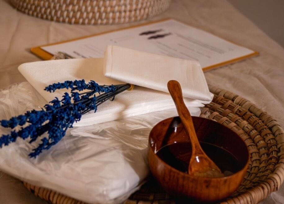 Relaxing spa essentials at Hisma Spa, Riyadh, Riyadh Province, SA, featuring lavender and a wooden bowl.