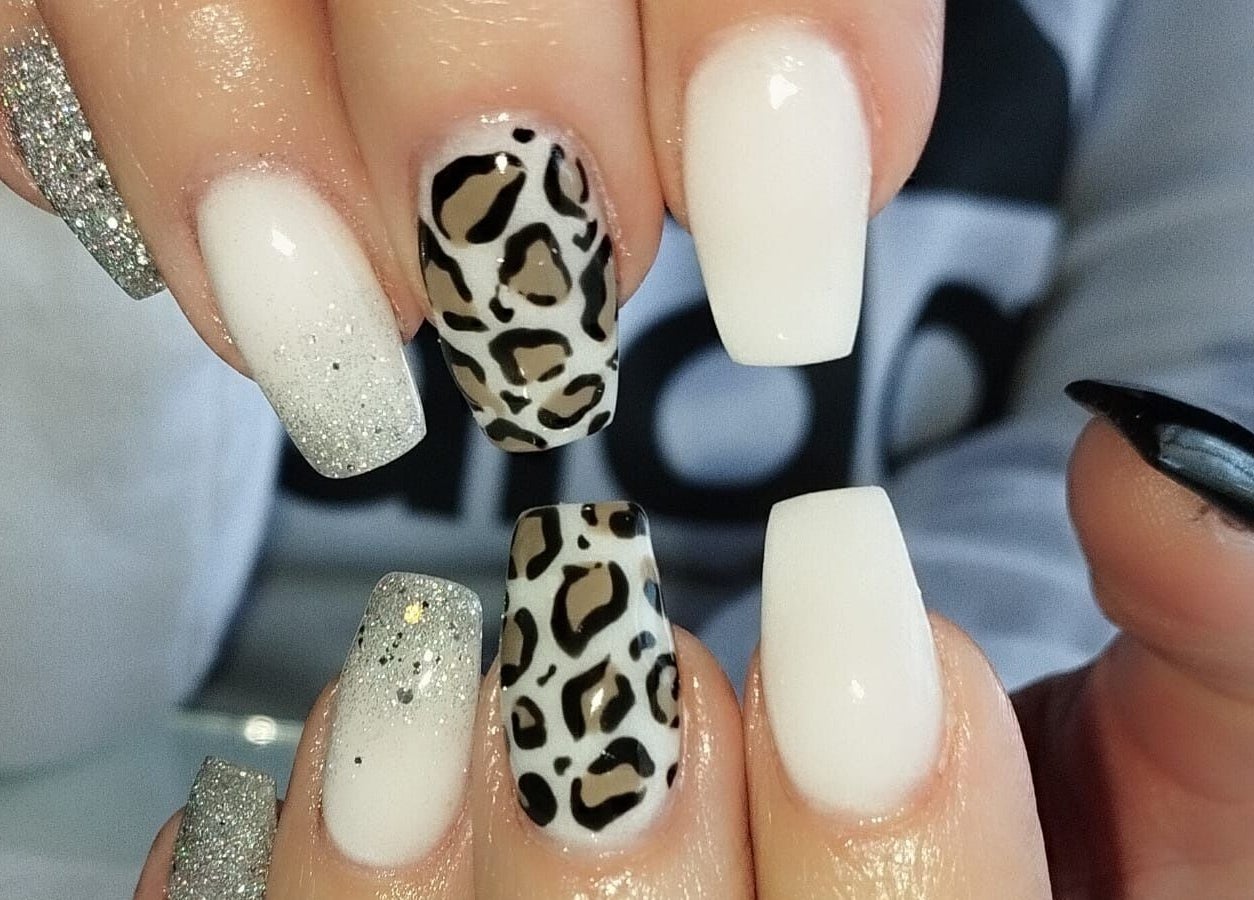 Leopard and glitter nail design at Classic Touch - Skincare & Nail Clinic in Rustenburg, North West, ZA.