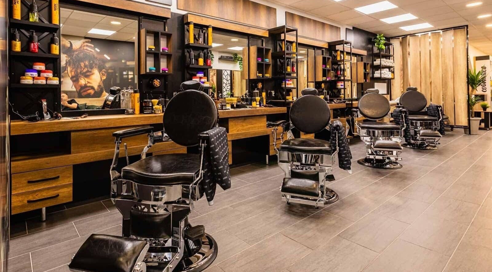Modern barber chairs line The Look Barnsley in Barnsley, England, GB, showcasing a stylish interior.