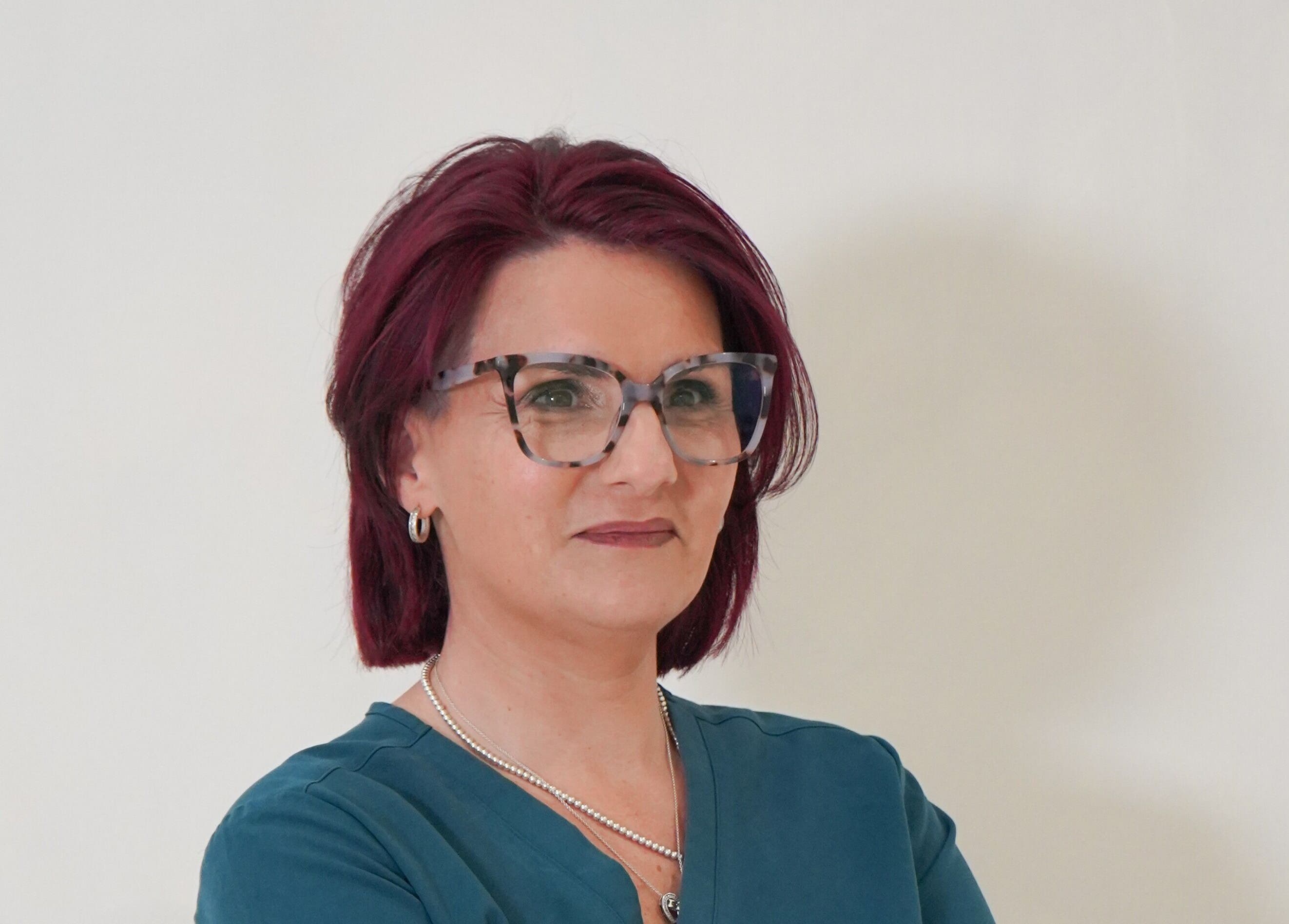 A professional from Aesthetics by Ria, Bournemouth, England, GB, with glasses and a confident expression.