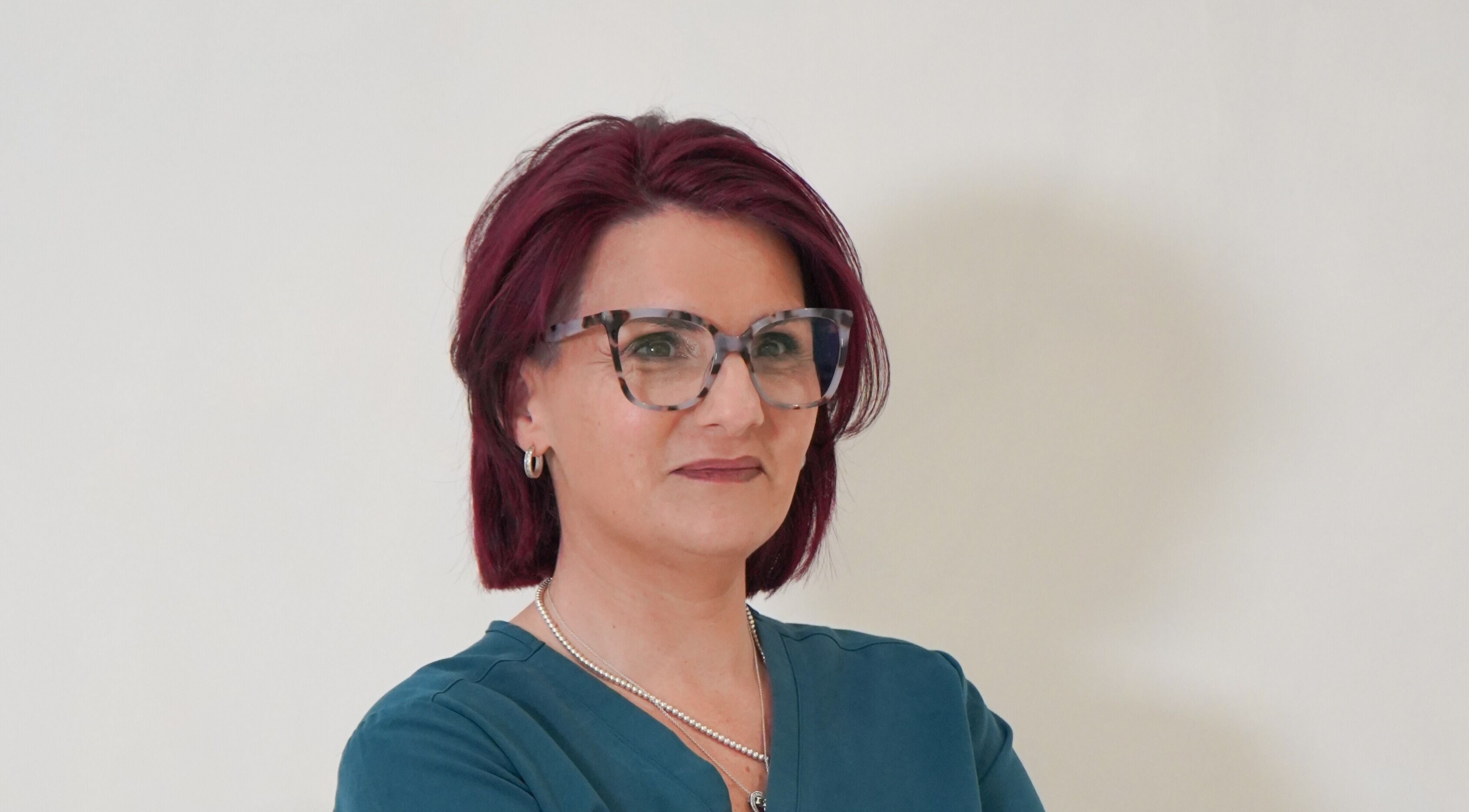 A professional from Aesthetics by Ria, Bournemouth, England, GB, with glasses and a confident expression.