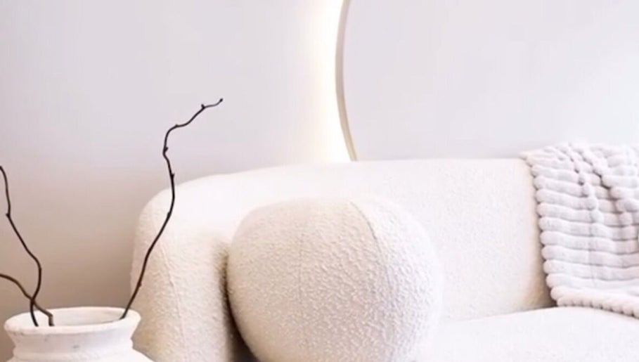 Elegant waiting area at Balance + Me, Denton, England, GB. Features plush white seating and decorative accents.