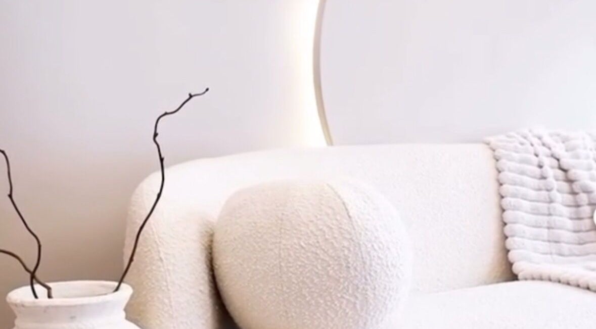 Elegant waiting area at Balance + Me, Denton, England, GB. Features plush white seating and decorative accents.