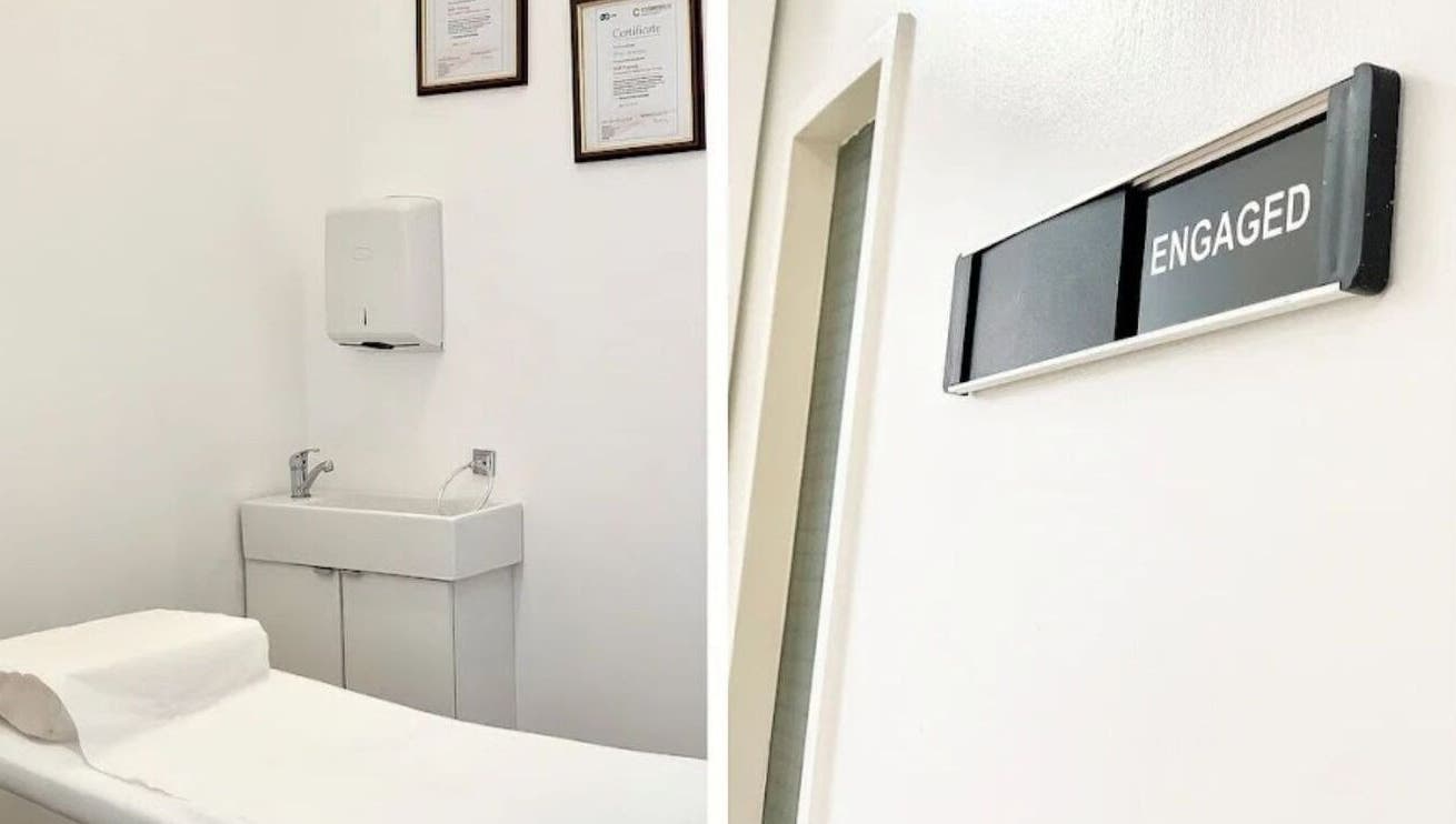 Treatment room at Essentials Aesthetic Clinic, London, England, GB, featuring clean decor and a massage table.