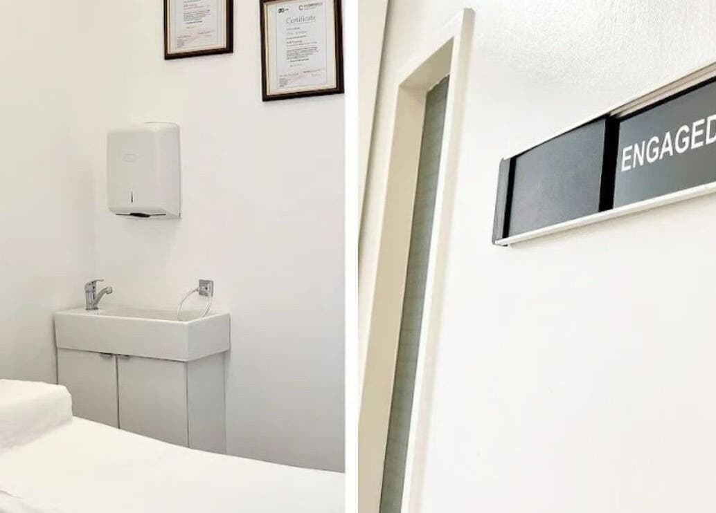 Treatment room at Essentials Aesthetic Clinic, London, England, GB, featuring clean decor and a massage table.