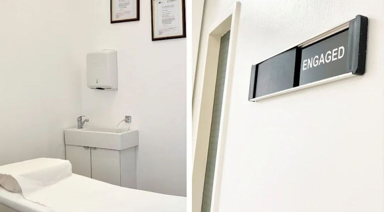 Treatment room at Essentials Aesthetic Clinic, London, England, GB, featuring clean decor and a massage table.
