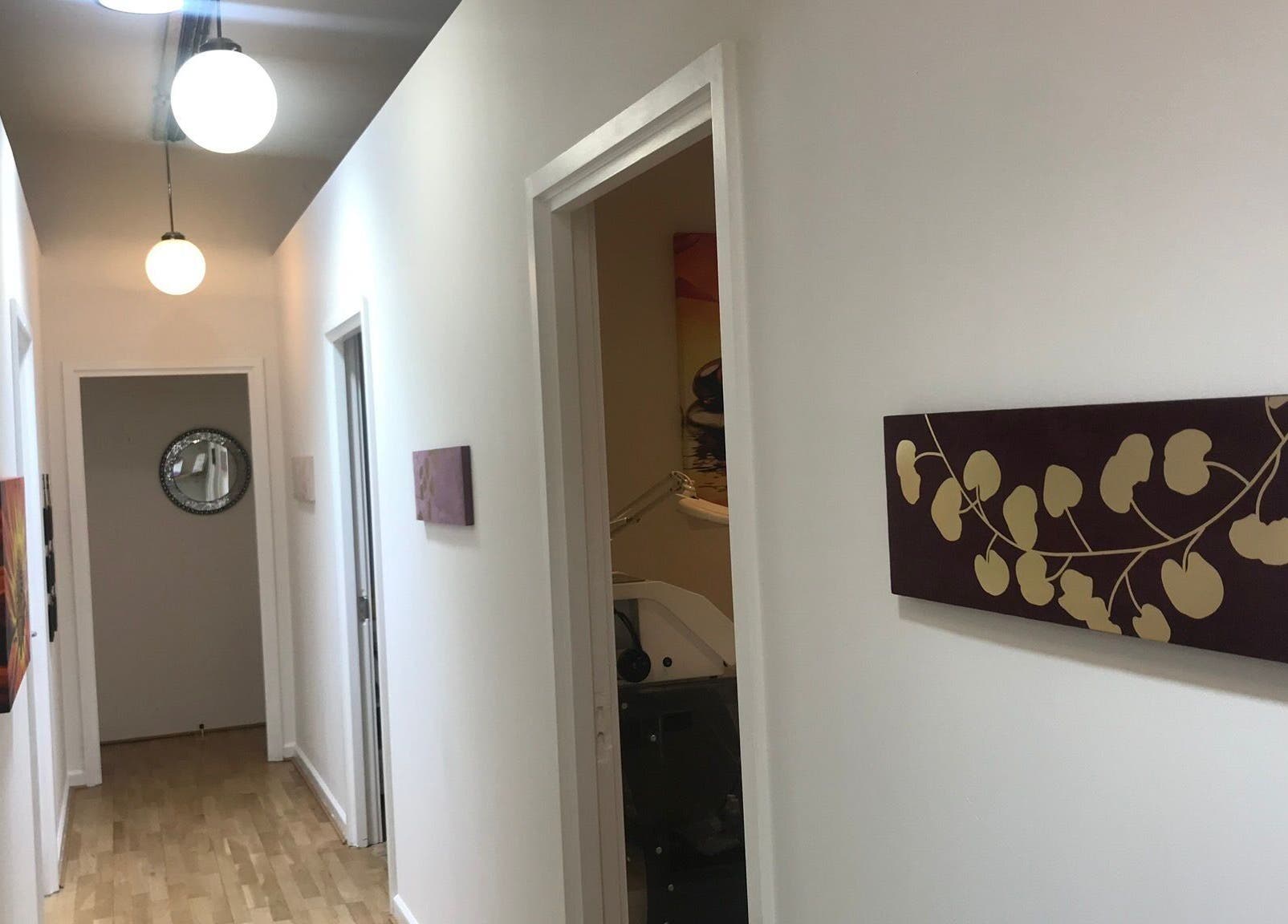 Bright hallway at Essentials Aesthetic Clinic in London, England, GB with modern decor.