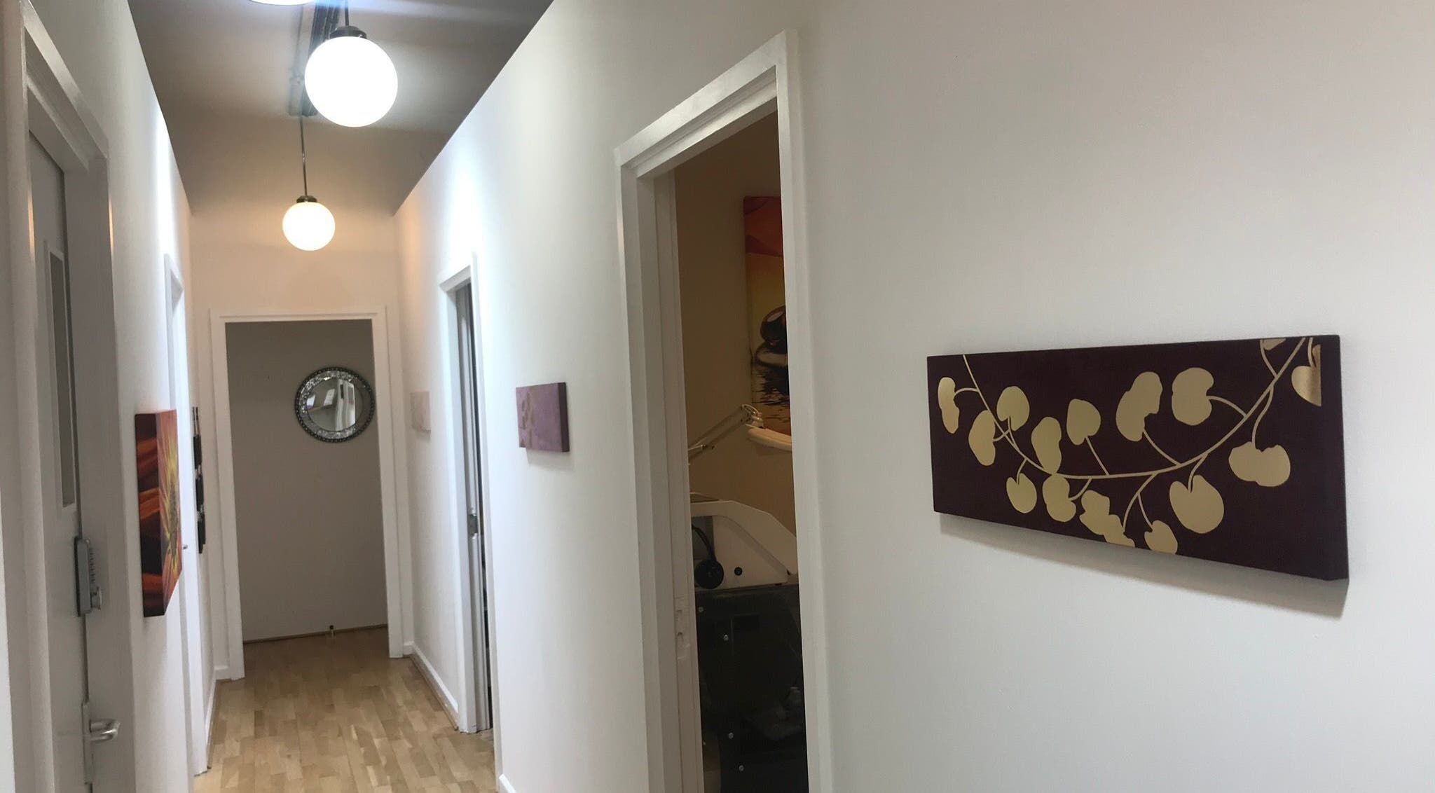 Bright hallway at Essentials Aesthetic Clinic in London, England, GB with modern decor.