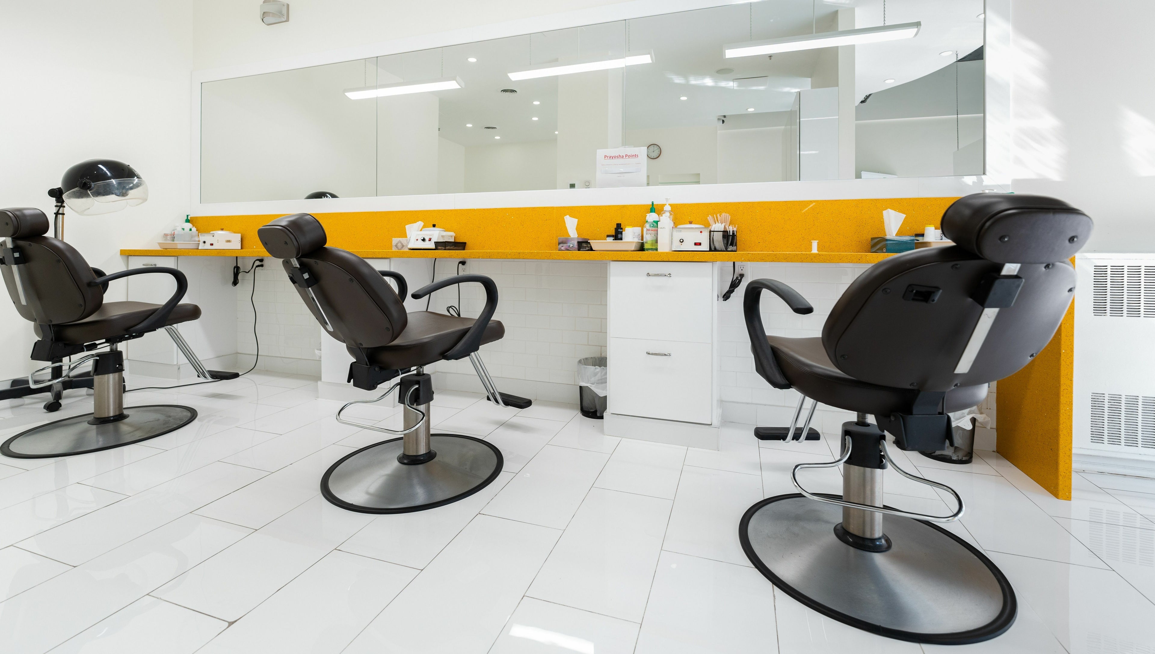 Modern salon chairs at Prayosha Threading & Wax Bar - Bathurst St., Toronto, Ontario, CA.