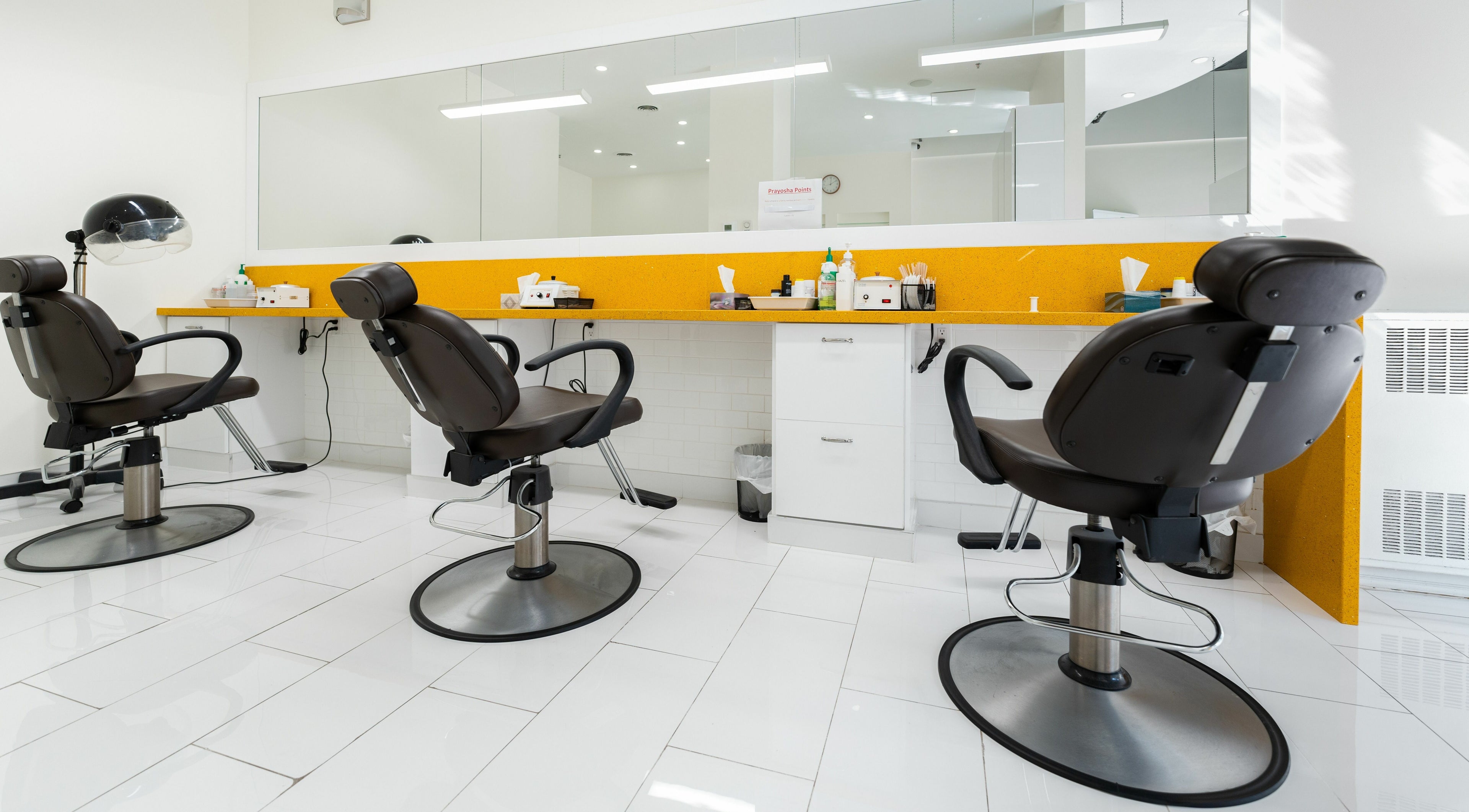 Modern salon chairs at Prayosha Threading & Wax Bar - Bathurst St., Toronto, Ontario, CA.