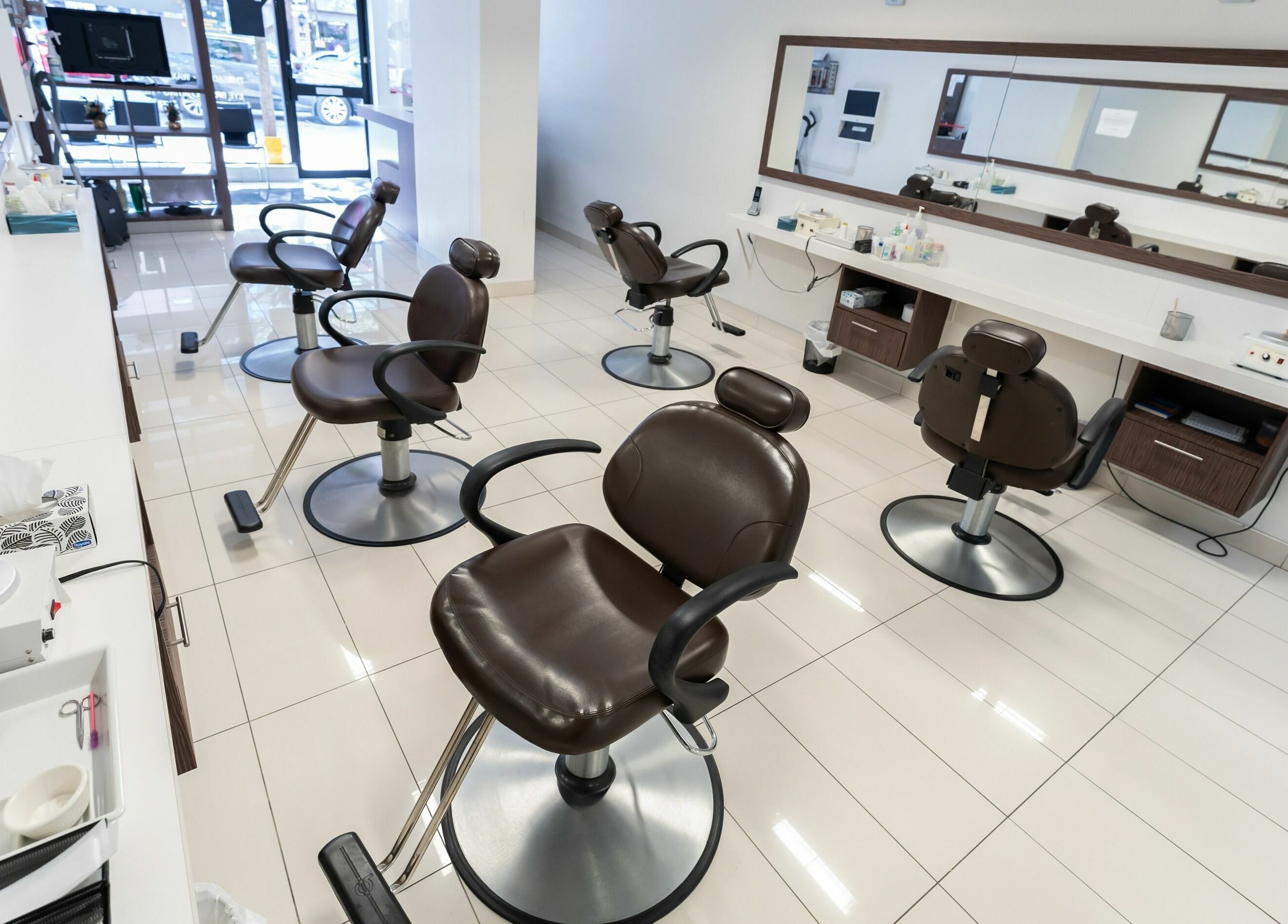 Prayosha Threading & Wax Bar - Yonge Street in Toronto, Ontario, CA features elegant styling chairs in a modern setting.