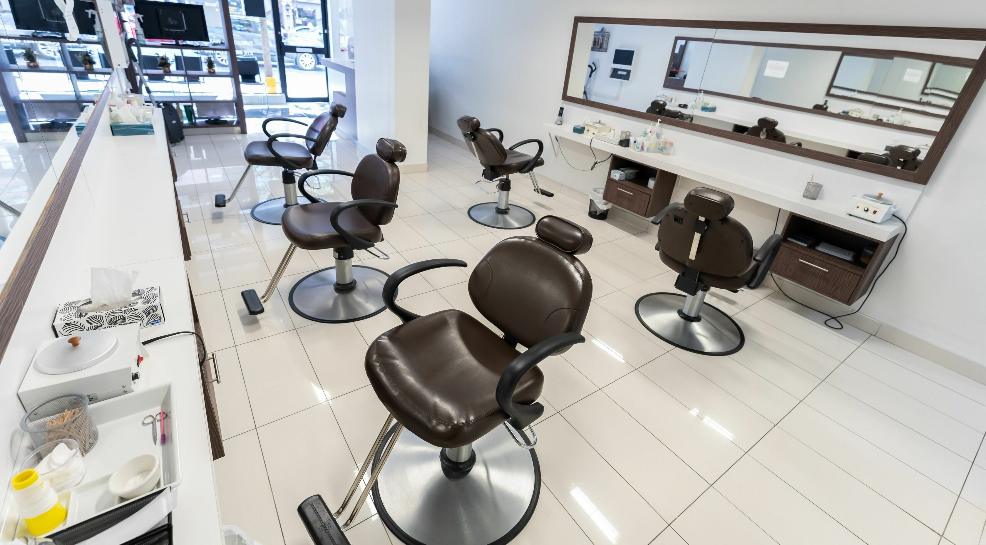 Prayosha Threading & Wax Bar - Yonge Street in Toronto, Ontario, CA features elegant styling chairs in a modern setting.