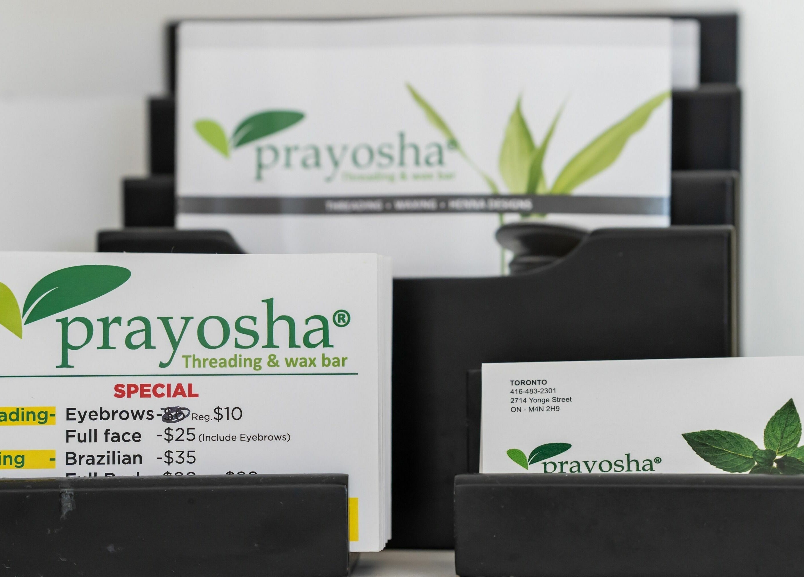 Business cards at Prayosha Threading & Wax Bar - Younge Street in Toronto, Ontario, CA.