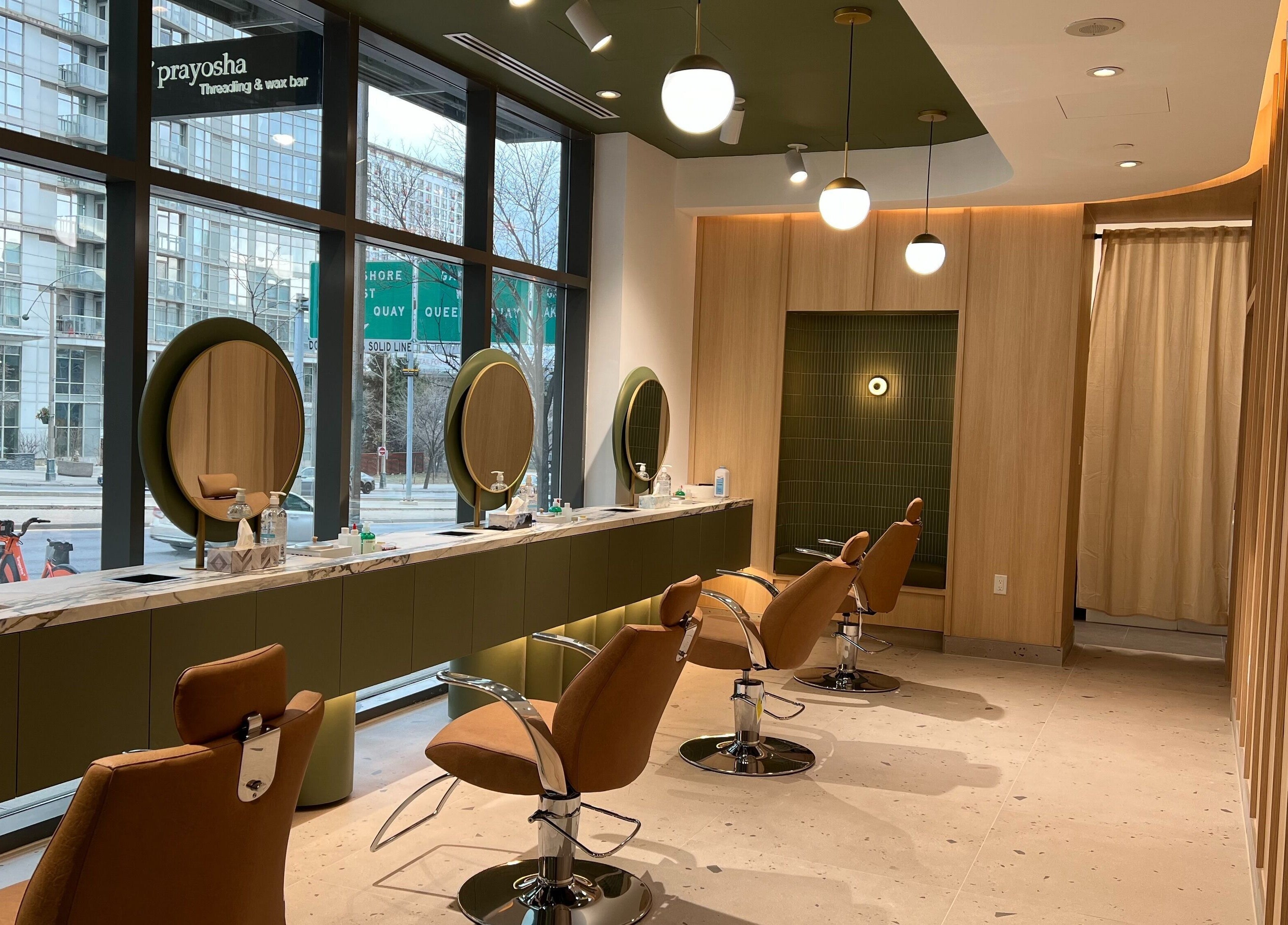 Elegant beauty space at Prayosha Threading & Wax Bar @ Spadina, Toronto, Ontario, CA with modern chairs and mirrors.