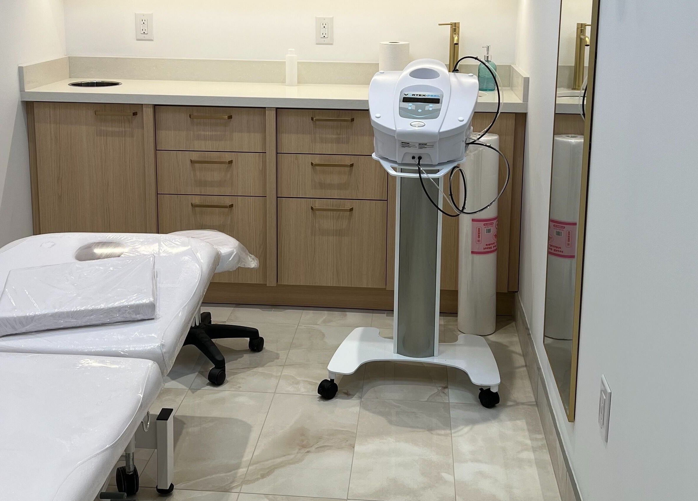 Cozy treatment room at Prayosha Threading & Wax Bar, Toronto, Ontario, CA featuring a treatment bed and equipment.