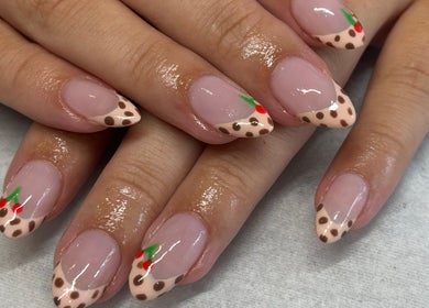 Stylish polka dot nails with cherry accents at Nails by Emma, Swanage, England, GB.