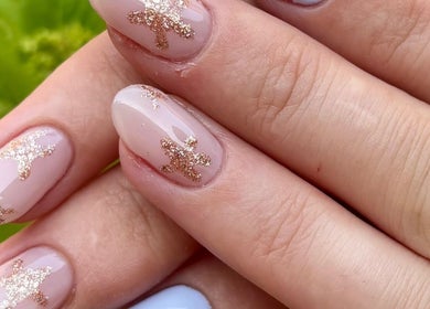 Stylish gold glitter nail art at Nails by Emma, Swanage, England, GB. Perfect for special occasions.