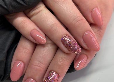 Manicured nails with glitter polish at Nails by Emma, Swanage, England, GB.