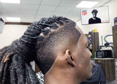 Close-up of a sleek dreadlock hairstyle in a modern barbershop at JaviiClipper.Cutz, Nassau, New Providence, BS.
