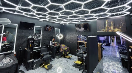Modern salon interior at JaviiClipper.Cutz, Nassau, New Providence, BS with chic black chairs and geometric lighting.