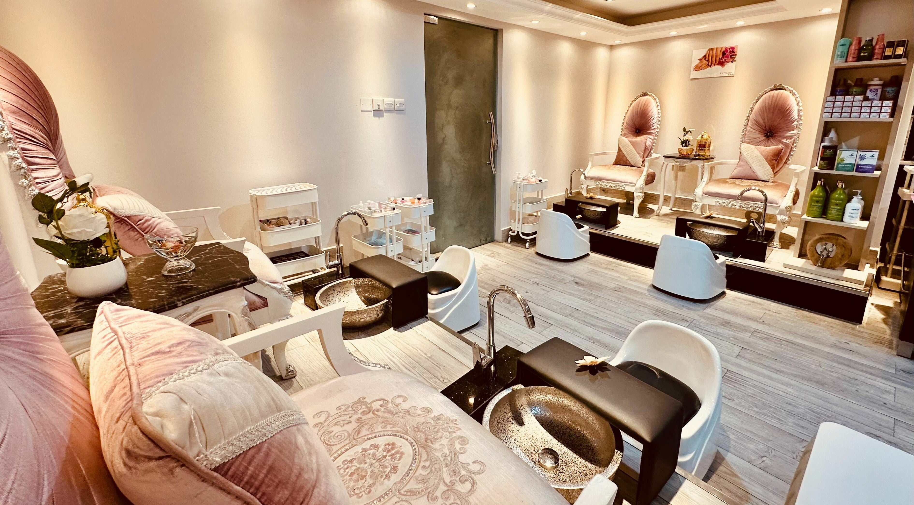Luxurious pedicure stations at Victoria Salon and Spa, Abu Dhabi, AE. Cozy pink chairs create a relaxing ambiance.