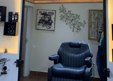 Elegant barber chair at Mr Spa, Muscat, Muscat Governorate, OM with stylish wall art.