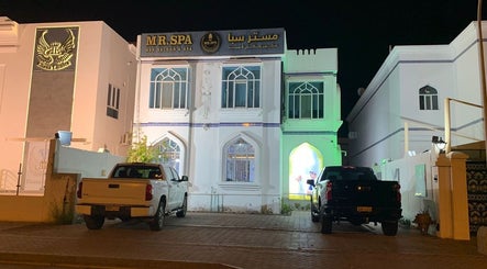 Front view of Mr Spa in Muscat, Muscat Governorate, OM, beautifully lit at night.