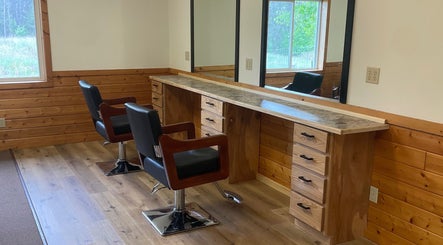 Signature Style Salon in Trego, Wisconsin, US features a rustic wooden styling station with black chairs.
