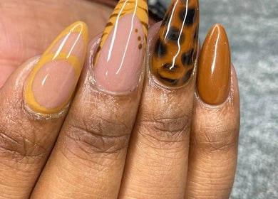 Stylish, intricate nail design at Nenebeauty bar, Centurion, Gauteng, ZA, featuring unique patterns and warm colors.