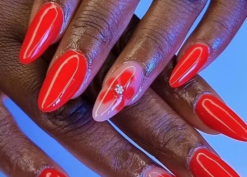 Bold red manicure with a floral accent at Nenebeauty bar, Centurion, Gauteng, ZA.